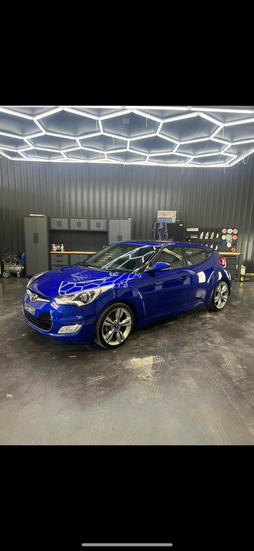 Blue Hyundai Veloster gloss finish under the workshop lights